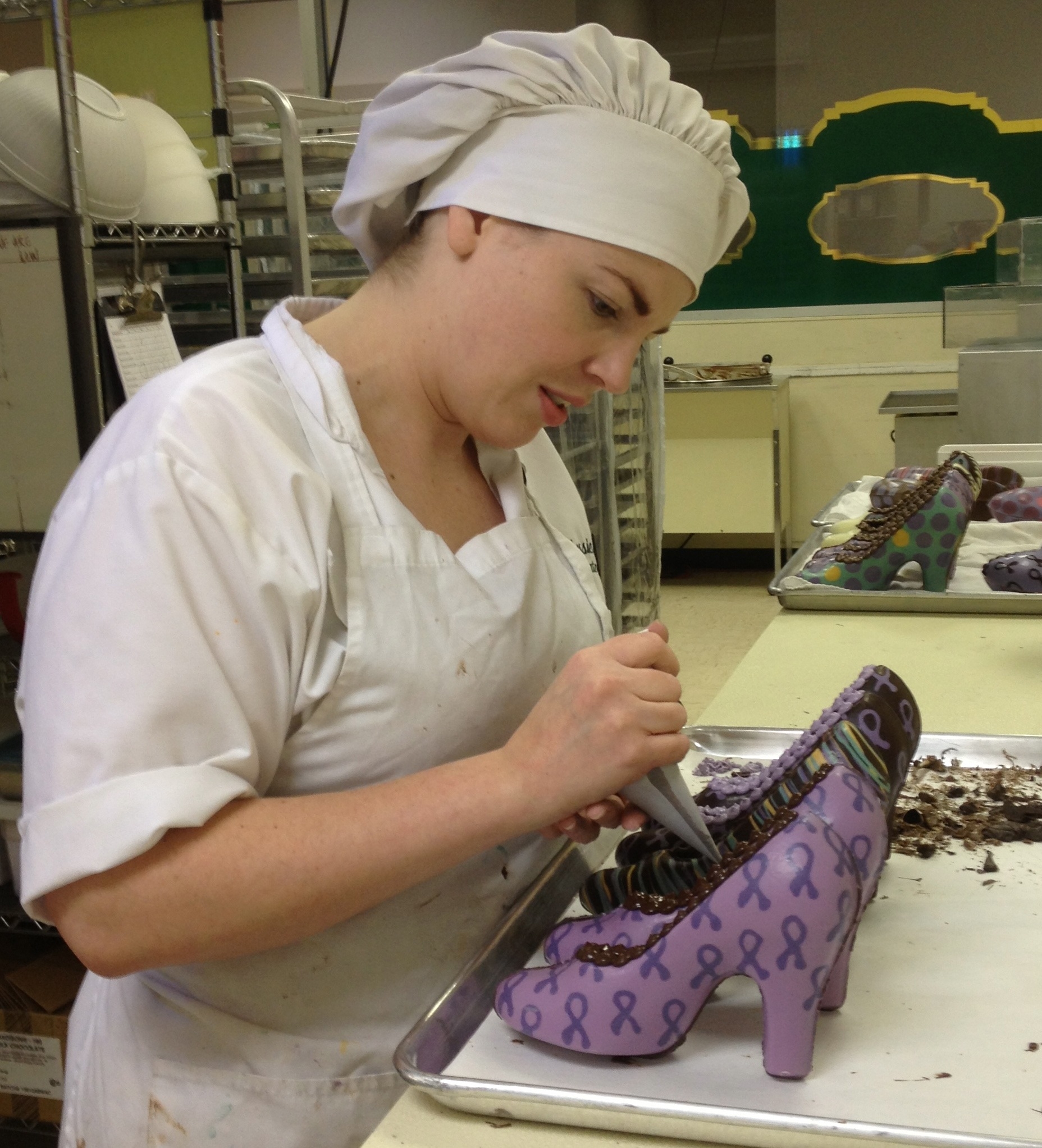Artist & Chocolatier Jessica Lied hand crafting chocolate high heel shoes.